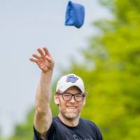 Dan Vainner throws a bag and watches it fly